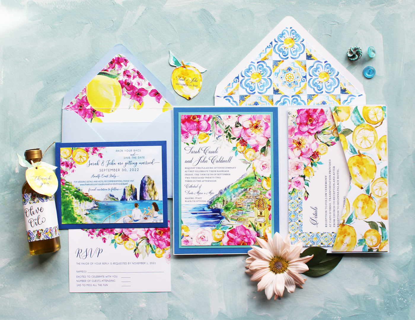 Floral and lemon-themed wedding invitation set with RSVP card, envelope, and bottle favor on a textured background. Includes floral designs, lemons, and a small flower decoration.