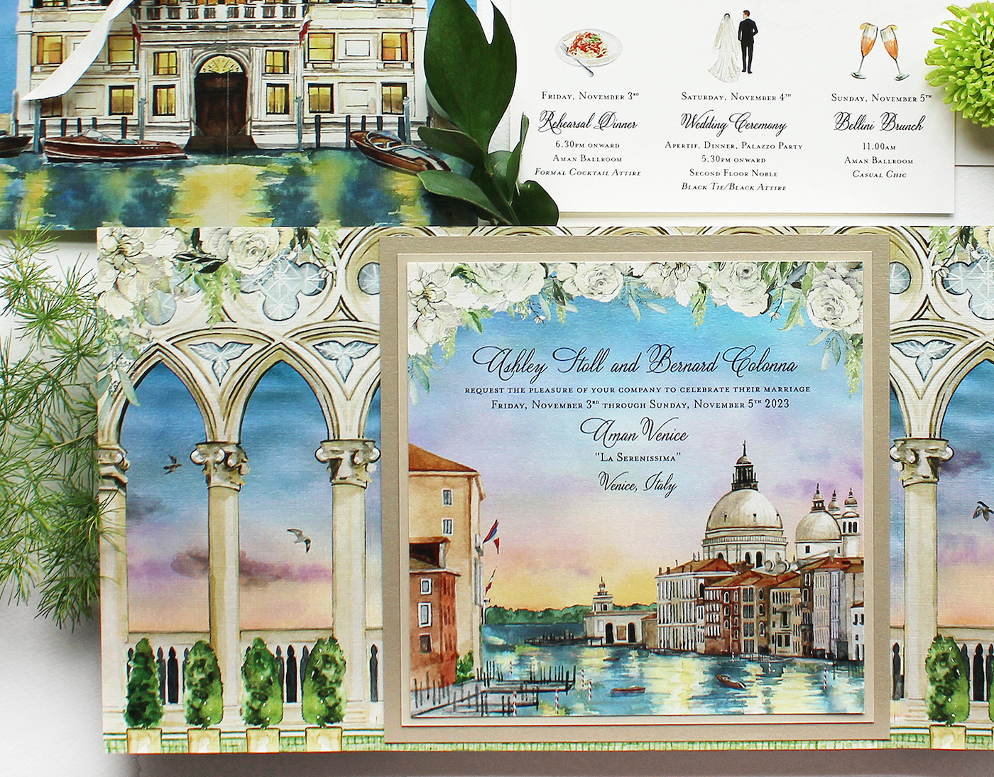 Ornate wedding invitation with watercolor illustrations of Venice, showing canals and historic buildings. Accompanied by florals and illustrations of attire.